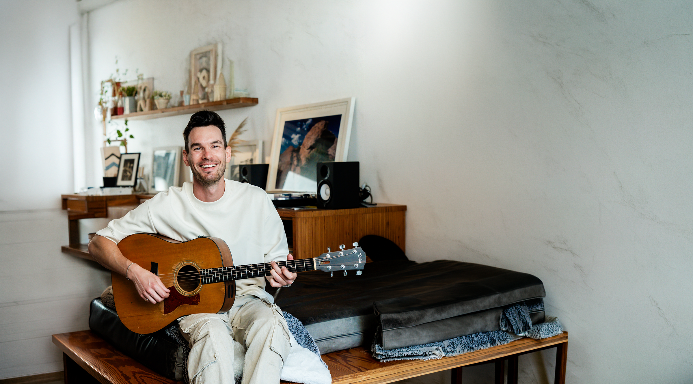 Ike Fontaine playing guitar in his studio
